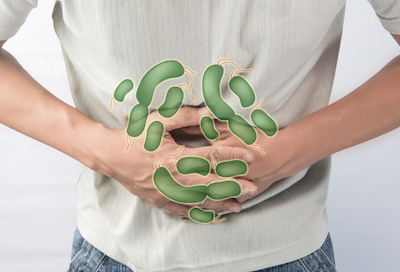 colitis causes man holding stomach