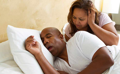 sleep apnea treatment man snoring in bed wife looking on