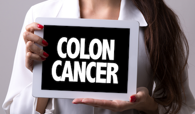 colon cancer symptoms woman holding sign