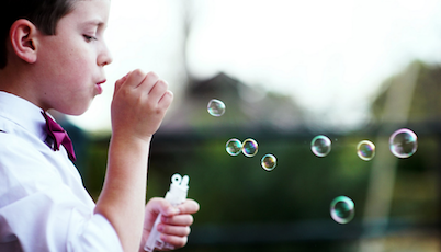 Autism treatment child blowing bubbles
